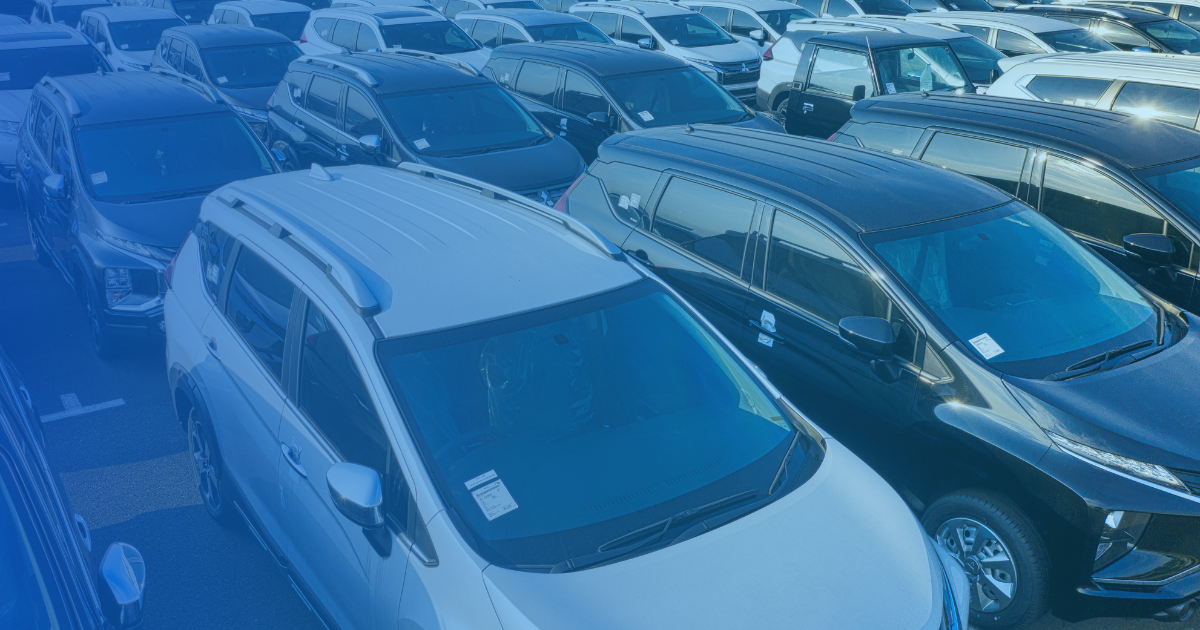 Car dealership manager reviewing market share performance on tablet