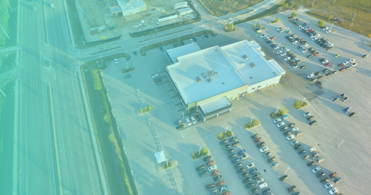 A dealership lot in birds-eye-view geotargeting for their streaming advertising campaign, with a teal gradient overlayed.