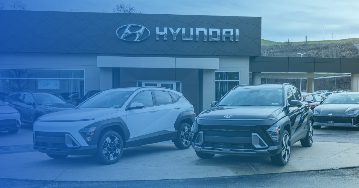 a group of Hyundai cars parked in front of a Hyundai dealership